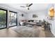 Bright living room boasts sliding doors, neutral sectional, and a view of the back yard at 16107 Dawnview Dr, Tampa, FL 33624