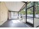 A screened-in patio offers a peaceful retreat with two white chairs and a table at 16107 Dawnview Dr, Tampa, FL 33624