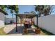 Backyard features an outdoor dining gazebo, spa, barbecue, and privacy fence at 1710 Shore Acres Ne Blvd, St Petersburg, FL 33703