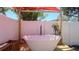 Backyard spa with a soaking tub and a privacy screen under a red canopy at 1710 Shore Acres Ne Blvd, St Petersburg, FL 33703