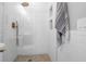 Glass enclosed shower with white subway tile and gold fixtures at 1710 Shore Acres Ne Blvd, St Petersburg, FL 33703