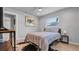 Bright bedroom featuring wood-look floors, natural light, and cool art at 1710 Shore Acres Ne Blvd, St Petersburg, FL 33703