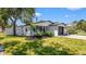 Beautifully landscaped home with black trim, brick driveway, and a well-maintained lawn at 1710 Shore Acres Ne Blvd, St Petersburg, FL 33703