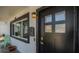 Close-up of the front door with black trim, modern lighting, and a unique mailbox at 1710 Shore Acres Ne Blvd, St Petersburg, FL 33703