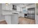 Modern kitchen featuring white cabinets, stainless steel appliances, and bright countertops at 1710 Shore Acres Ne Blvd, St Petersburg, FL 33703