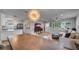 Open-concept living room featuring hardwood floors, modern decor, and a stylish dining area at 1710 Shore Acres Ne Blvd, St Petersburg, FL 33703