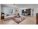 Bright, open living room featuring hardwood floors, a stylish rug, and modern furnishings at 1710 Shore Acres Ne Blvd, St Petersburg, FL 33703