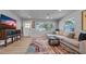 Bright living room featuring hardwood floors, a stylish rug, and modern furnishings at 1710 Shore Acres Ne Blvd, St Petersburg, FL 33703
