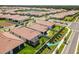 Aerial view of backyard and lush landscaping in a well-maintained residential neighborhood at 17249 Star Banks St, Wimauma, FL 33598