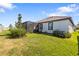 Well-maintained backyard with lush green grass, a screened-in patio, and privacy fencing at 17249 Star Banks St, Wimauma, FL 33598