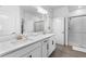 Modern bathroom with double sink vanity, sleek fixtures, and glass-enclosed shower at 17249 Star Banks St, Wimauma, FL 33598