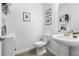 Stylish powder room featuring pedestal sink, decorative accents and tile floors at 17249 Star Banks St, Wimauma, FL 33598