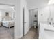 Bright bathroom with double sinks, quartz countertop and access to commode and primary bedroom at 17249 Star Banks St, Wimauma, FL 33598