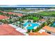 Aerial view of a luxurious community pool featuring palm trees and multiple lounge chairs at 17249 Star Banks St, Wimauma, FL 33598