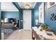 Welcoming foyer with stylish decor, wood-look tile flooring, and elegant blue walls at 17249 Star Banks St, Wimauma, FL 33598
