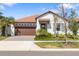 Beautiful single-story home with a tile roof, attached two-car garage, and mature landscaping at 17249 Star Banks St, Wimauma, FL 33598