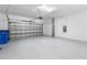 A clean and spacious garage featuring an automatic door and plenty of open storage space at 17249 Star Banks St, Wimauma, FL 33598