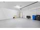 Bright and airy garage with epoxy flooring and storage options with plenty of room for two cars at 17249 Star Banks St, Wimauma, FL 33598