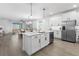 Spacious kitchen featuring a center island, white cabinets, stainless appliances, and open layout at 17249 Star Banks St, Wimauma, FL 33598