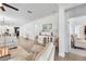 Spacious living room featuring modern decor, light hardwood floors, and an open floor plan to the kitchen at 17249 Star Banks St, Wimauma, FL 33598