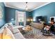 Comfortable living room with a plush sectional sofa, rocking chair, and modern decor at 17249 Star Banks St, Wimauma, FL 33598