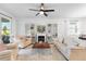 Open-concept living room featuring a fireplace, built-in bookcases, and bright furnishings at 17249 Star Banks St, Wimauma, FL 33598
