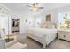 Elegant main bedroom suite with floral wallpaper, two windows, and a large walk-in closet at 17249 Star Banks St, Wimauma, FL 33598