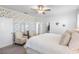 Bright main bedroom featuring floral wallpaper, plush carpeting, and ample natural light at 17249 Star Banks St, Wimauma, FL 33598