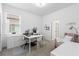 Well-lit home office space with desk, shelving, and a view of the backyard at 17249 Star Banks St, Wimauma, FL 33598