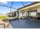 Spacious screened patio with an outdoor dining and lounge area, perfect for entertaining and relaxation at 17249 Star Banks St, Wimauma, FL 33598