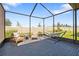 Relaxing screened patio with a hammock, cushioned seating, and serene views of the beautifully landscaped backyard at 17249 Star Banks St, Wimauma, FL 33598