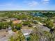 Aerial view of a lovely home in a quiet neighborhood with a lake nearby at 180 Rusk Cir, Spring Hill, FL 34606