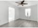 Bright bedroom featuring wood-look flooring and an updated ceiling fan at 180 Rusk Cir, Spring Hill, FL 34606