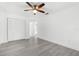 Spacious bedroom featuring wood-look floors, a closet, and neutral walls at 180 Rusk Cir, Spring Hill, FL 34606