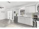 Bright kitchen featuring modern appliances, white cabinets, stainless steel dishwasher, and quartz countertops at 180 Rusk Cir, Spring Hill, FL 34606