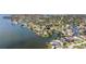 Aerial shot of a waterfront home surrounded by lush trees and water at 1811 Bayou Grande Ne Blvd, St Petersburg, FL 33703