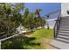 A beautiful backyard with lush green grass, partial fence, and mature trees at 1811 Bayou Grande Ne Blvd, St Petersburg, FL 33703