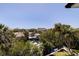 Aerial backyard view showcasing boats on the canal, lush greenery, and tiki hut at 1811 Bayou Grande Ne Blvd, St Petersburg, FL 33703