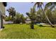 Spacious backyard with lush greenery and a waterfront view at 1811 Bayou Grande Ne Blvd, St Petersburg, FL 33703