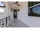 Balcony with black railing and exterior door showcases modern architecture with gray tile at 1811 Bayou Grande Ne Blvd, St Petersburg, FL 33703