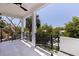 Enjoy the outdoors with a spacious covered balcony with black railing and tree views at 1811 Bayou Grande Ne Blvd, St Petersburg, FL 33703