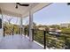 Expansive covered balcony with modern black railings offering scenic neighborhood and waterfront views at 1811 Bayou Grande Ne Blvd, St Petersburg, FL 33703
