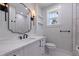 Modern bathroom with floating vanity, black matte faucet, a sleek mirror, and tile surround glass shower at 1811 Bayou Grande Ne Blvd, St Petersburg, FL 33703