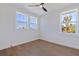 This bright, modern bedroom features hardwood floors, two large windows, a contemporary ceiling fan, and natural light at 1811 Bayou Grande Ne Blvd, St Petersburg, FL 33703
