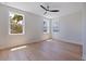 Bright bedroom featuring hardwood floors, a modern ceiling fan, and natural light at 1811 Bayou Grande Ne Blvd, St Petersburg, FL 33703