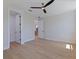 Bedroom with wood floors, ceiling fan, and access to closet space at 1811 Bayou Grande Ne Blvd, St Petersburg, FL 33703