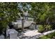 View of the waterfront boat lift with a boat docked, surrounded by lush landscaping at 1811 Bayou Grande Ne Blvd, St Petersburg, FL 33703
