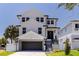 Beautiful two-story home featuring a modern design, crisp white siding, and a spacious two-car garage at 1811 Bayou Grande Ne Blvd, St Petersburg, FL 33703