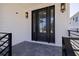 Stylish front door with glass panels, modern lighting, and a charming porch area at 1811 Bayou Grande Ne Blvd, St Petersburg, FL 33703