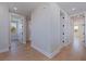 Bright hallway showcasing beautiful hardwood floors and access to multiple rooms with white trim at 1811 Bayou Grande Ne Blvd, St Petersburg, FL 33703